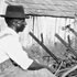 Picture of two men working on a farm in Macon County, Alabama, in the early 20th century
